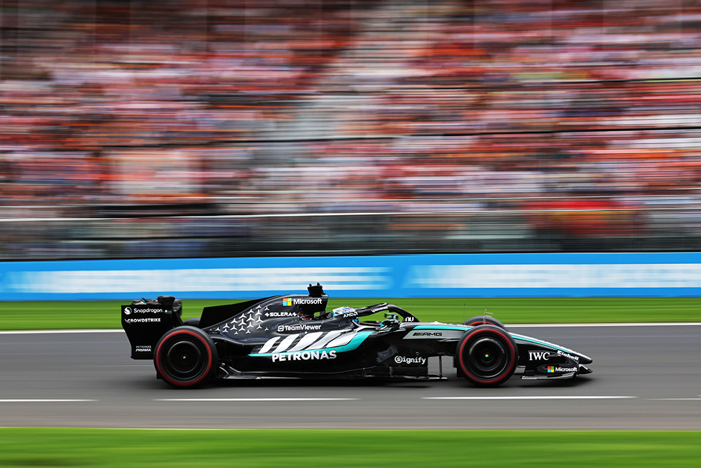 Formula 1 race car driving on a racetrack during a race.